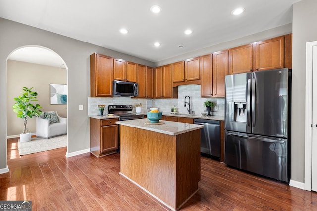 51 Stonebridge Way, Newnan, GA 30265 - kitchen with appliances with stainless steel finishes, tasteful backsplash, dark wood-style flooring, arched walkways, and recessed lighting