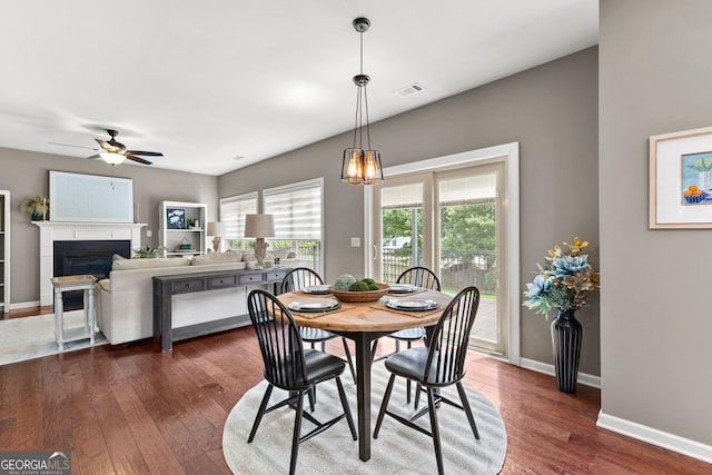 51 Stonebridge Way, Newnan, GA 30265 - dining area featuring a ceiling fan, dark wood-style floors, and a fireplace