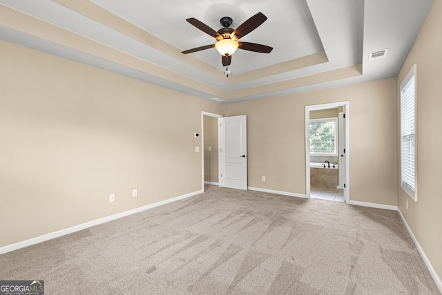 51 Stonebridge Way, Newnan, GA 30265 - unfurnished bedroom with carpet, a tray ceiling, and connected bathroom