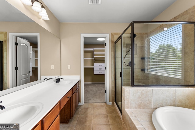 51 Stonebridge Way, Newnan, GA 30265 - full bathroom featuring a stall shower, double vanity, a bath, a walk in closet, and tile patterned flooring