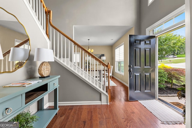 51 Stonebridge Way, Newnan, GA 30265 - entryway featuring stairs, wood finished floors, a towering ceiling, and a chandelier