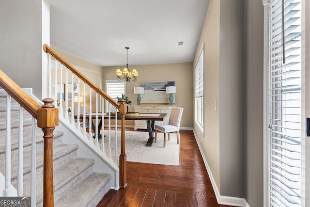 51 Stonebridge Way, Newnan, GA 30265 - dining area with healthy amount of natural light, a chandelier, dark wood-style flooring, and stairs