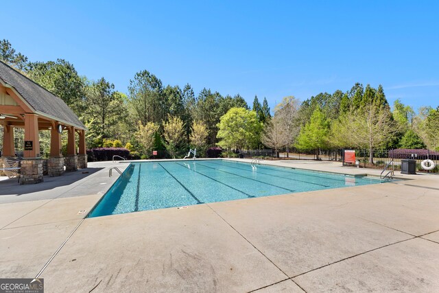 51 Stonebridge Way, Newnan, GA 30265 - community pool with a patio area, a gazebo, and view of scattered trees
