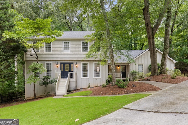 2240 Six Branches Dr, Roswell, GA 30076 - colonial inspired home featuring a front lawn and a shingled roof