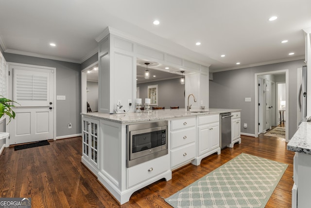 2240 Six Branches Dr, Roswell, GA 30076 - kitchen featuring appliances with stainless steel finishes, crown molding, white cabinets, light stone counters, and recessed lighting