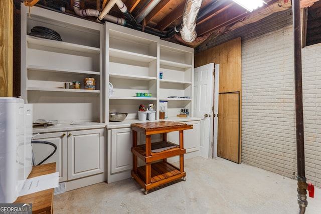 2240 Six Branches Dr, Roswell, GA 30076 - unfinished below grade area featuring brick wall