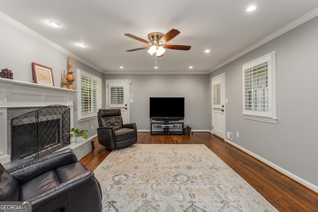 2240 Six Branches Dr, Roswell, GA 30076 - living area with dark wood-type flooring, a ceiling fan, recessed lighting, a fireplace with raised hearth, and ornamental molding
