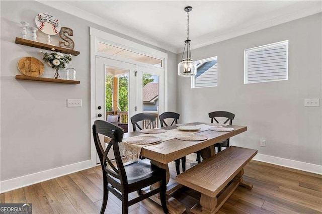 338 Boundless Ln, Canton, GA 30114 - dining space featuring wood finished floors, a chandelier, and ornamental molding
