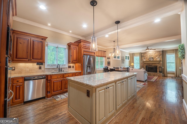 2403 Wistful Way, Marietta, GA 30066 - kitchen featuring stainless steel appliances, a kitchen island, dark wood-type flooring, crown molding, and brown cabinetry