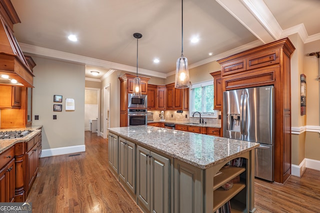 2403 Wistful Way, Marietta, GA 30066 - kitchen with appliances with stainless steel finishes, ornamental molding, dark wood-type flooring, a center island, and light stone countertops
