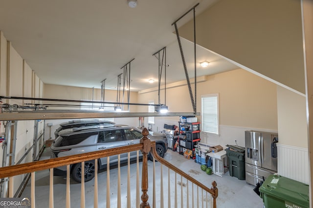 2403 Wistful Way, Marietta, GA 30066 - garage with stainless steel fridge with ice dispenser and a wainscoted wall