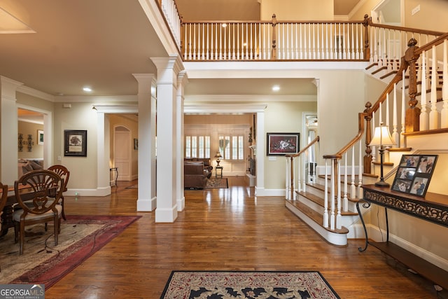 2403 Wistful Way, Marietta, GA 30066 - foyer entrance with crown molding, wood finished floors, arched walkways, stairs, and ornate columns