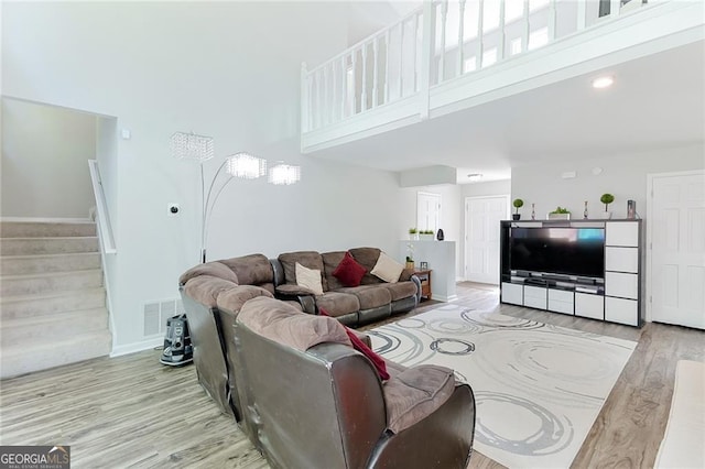 4180 Pineset Dr, Alpharetta, GA 30022 - living room with wood finished floors, a high ceiling, and stairway