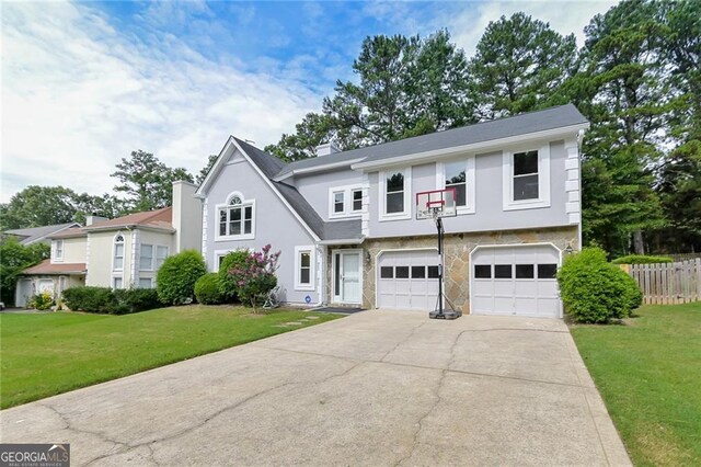 4180 Pineset Dr, Alpharetta, GA 30022 - view of front facade with an attached garage, driveway, stucco siding, a chimney, and stone siding