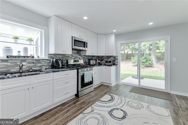 4180 Pineset Dr, Alpharetta, GA 30022 - kitchen featuring appliances with stainless steel finishes, decorative backsplash, white cabinetry, dark wood-style floors, and recessed lighting