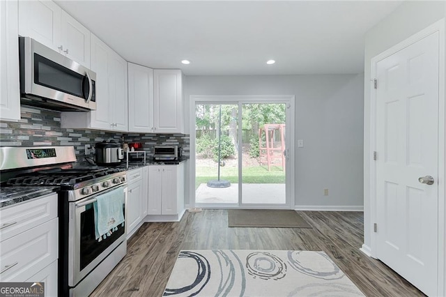 4180 Pineset Dr, Alpharetta, GA 30022 - kitchen with stainless steel appliances, tasteful backsplash, white cabinets, light wood-style floors, and recessed lighting