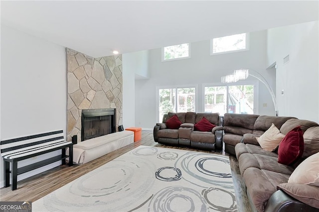 4180 Pineset Dr, Alpharetta, GA 30022 - living area with wood finished floors, healthy amount of natural light, a towering ceiling, and a fireplace