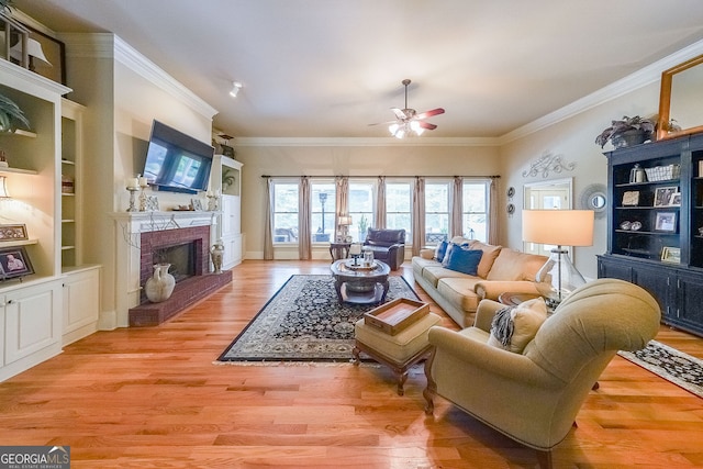 750 Old Loganville Rd SW, Loganville, GA 30052 - living area with ceiling fan, a fireplace, crown molding, light wood-style flooring, and built in features
