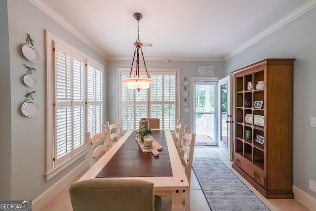 750 Old Loganville Rd SW, Loganville, GA 30052 - dining room with healthy amount of natural light, light tile patterned floors, and crown molding