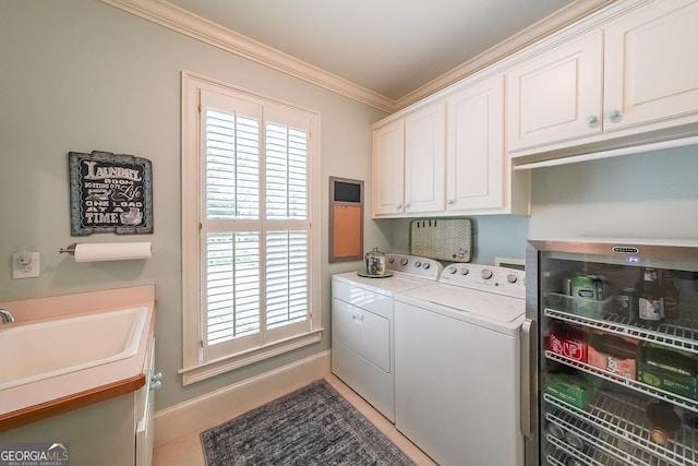 750 Old Loganville Rd SW, Loganville, GA 30052 - washroom with washer and clothes dryer, crown molding, cabinet space, and healthy amount of natural light