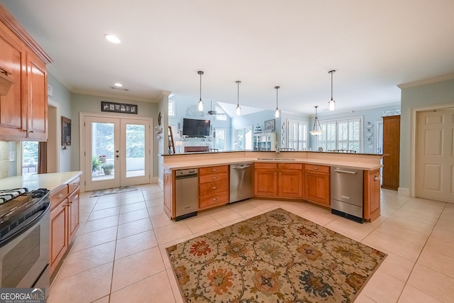 750 Old Loganville Rd SW, Loganville, GA 30052 - kitchen featuring stainless steel appliances, crown molding, light countertops, french doors, and hanging light fixtures