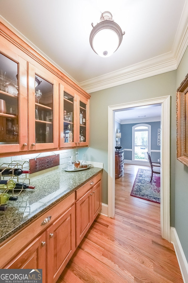 750 Old Loganville Rd SW, Loganville, GA 30052 - bar with ornamental molding, light wood finished floors, and backsplash
