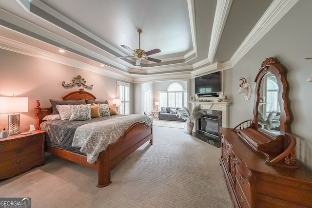 750 Old Loganville Rd SW, Loganville, GA 30052 - bedroom featuring carpet, a fireplace, crown molding, a tray ceiling, and ceiling fan