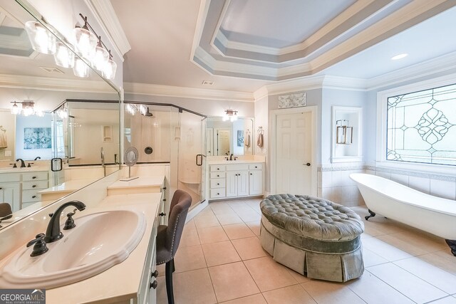 750 Old Loganville Rd SW, Loganville, GA 30052 - bathroom featuring a shower stall, tile patterned flooring, a soaking tub, two vanities, and ornamental molding