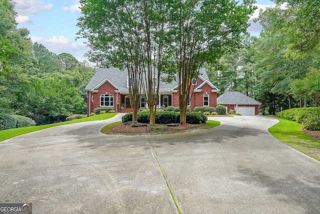 750 Old Loganville Rd SW, Loganville, GA 30052 - view of front of house with an outbuilding, a garage, and brick siding