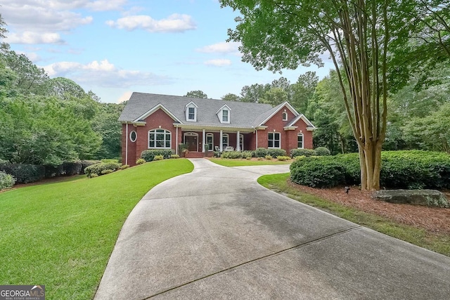 750 Old Loganville Rd SW, Loganville, GA 30052 - view of front of property featuring brick siding, covered porch, a front yard, and curved driveway