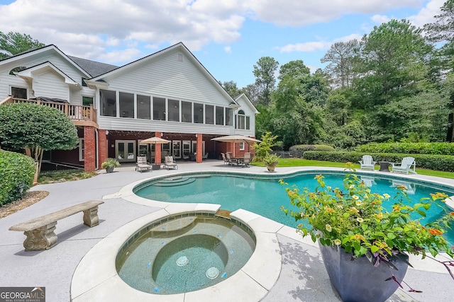 750 Old Loganville Rd SW, Loganville, GA 30052 - view of swimming pool featuring a patio area, a sunroom, french doors, and a pool with connected hot tub