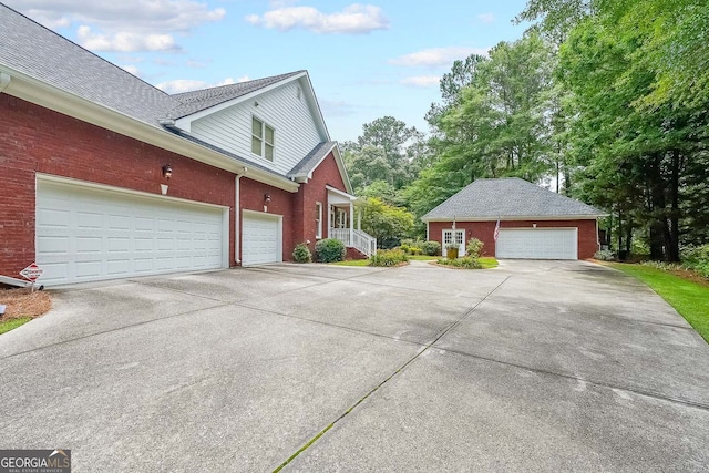 750 Old Loganville Rd SW, Loganville, GA 30052 - view of property exterior featuring brick siding, a garage, and concrete driveway