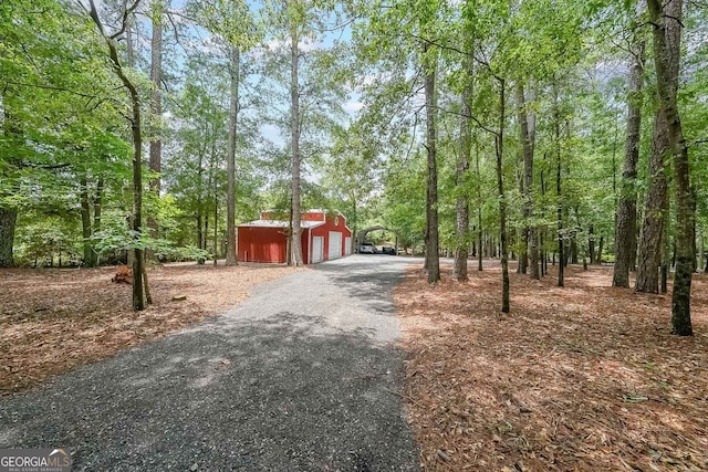 750 Old Loganville Rd SW, Loganville, GA 30052 - view of asphalt driveway with a wooded view