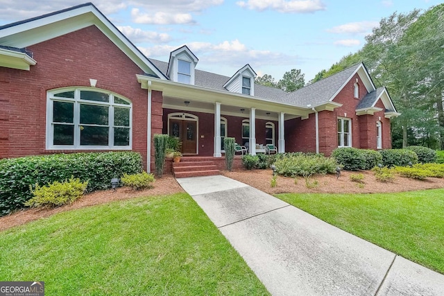 750 Old Loganville Rd SW, Loganville, GA 30052 - view of front facade featuring a front yard, covered porch, and brick siding