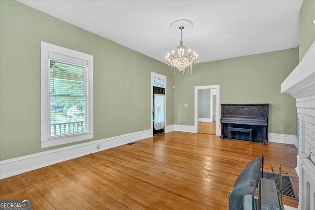 226 Noyes St, Cedartown, GA 30125 - unfurnished living room featuring a chandelier and wood-type flooring