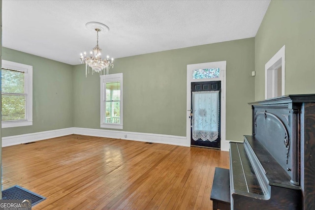 226 Noyes St, Cedartown, GA 30125 - entrance foyer featuring hardwood / wood-style flooring, a chandelier, plenty of natural light, and a textured ceiling