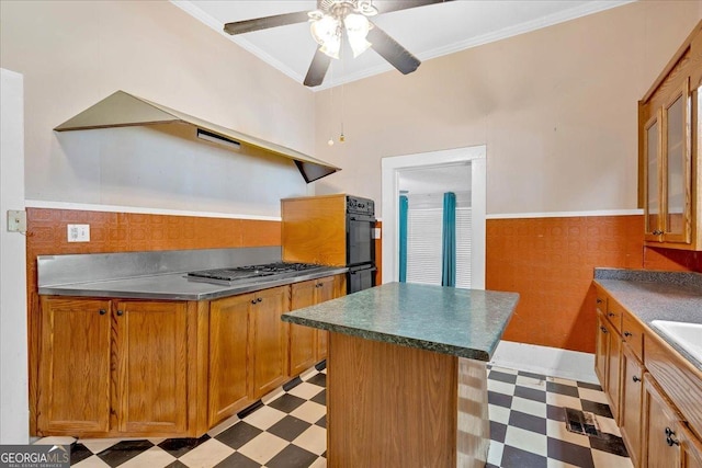 226 Noyes St, Cedartown, GA 30125 - kitchen with light flooring, brown cabinetry, wainscoting, a ceiling fan, and oven