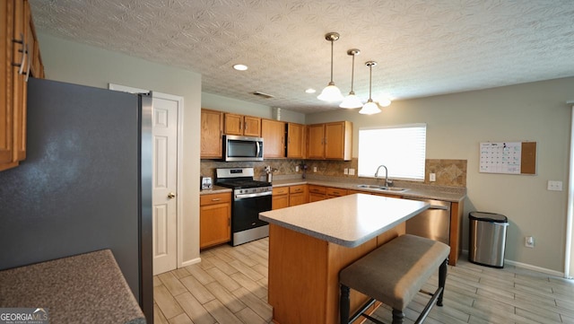 400 Silver Spring St, Dallas, GA 30157 - kitchen featuring appliances with stainless steel finishes, tasteful backsplash, wood tiled floors, and a breakfast bar area