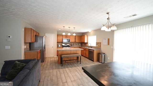 400 Silver Spring St, Dallas, GA 30157 - kitchen with stainless steel appliances, a kitchen breakfast bar, open floor plan, tasteful backsplash, and light wood-type flooring