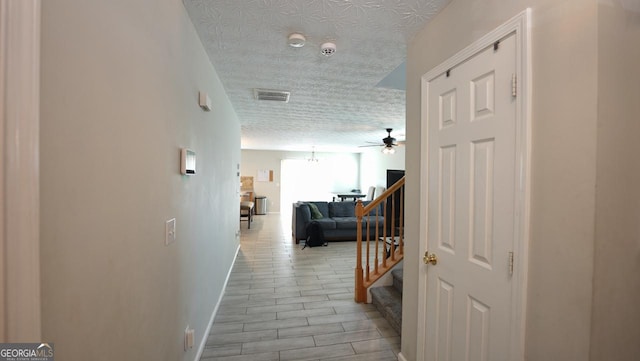 400 Silver Spring St, Dallas, GA 30157 - corridor featuring a textured ceiling, stairs, and light wood-style floors