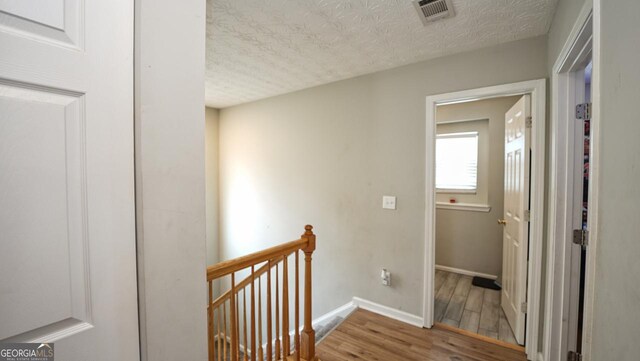 400 Silver Spring St, Dallas, GA 30157 - corridor featuring an upstairs landing, a textured ceiling, and wood finished floors