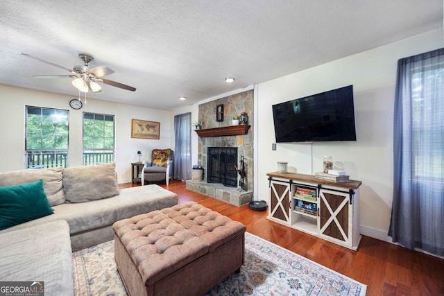 1101 Moon Rd, Shiloh, GA 31826 - living area with ceiling fan, a stone fireplace, wood finished floors, recessed lighting, and a textured ceiling