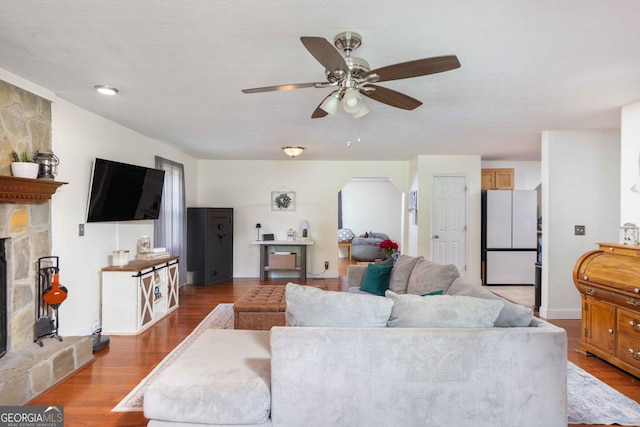1101 Moon Rd, Shiloh, GA 31826 - living room with ceiling fan, wood finished floors, a fireplace, and arched walkways