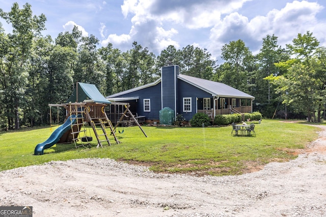 1101 Moon Rd, Shiloh, GA 31826 - view of property exterior featuring a playground, a yard, a chimney, and view of wooded area