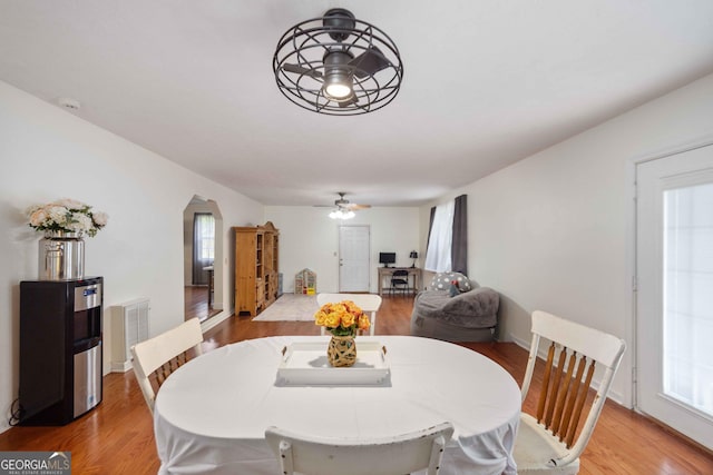 1101 Moon Rd, Shiloh, GA 31826 - dining space with ceiling fan, arched walkways, and light wood-style flooring