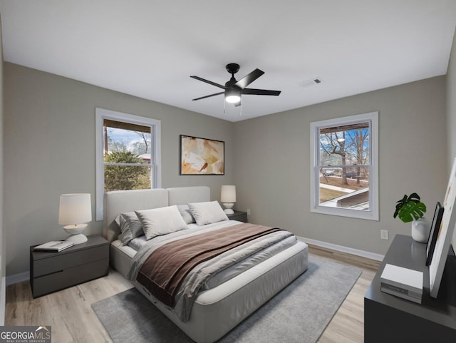 2308 Mark Trl, Decatur, GA 30032 - bedroom featuring multiple windows, light wood-style floors, and a ceiling fan