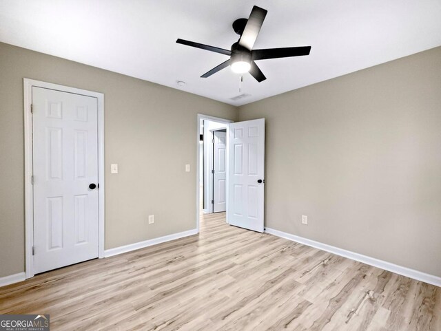 2308 Mark Trl, Decatur, GA 30032 - unfurnished bedroom featuring light wood finished floors and a ceiling fan