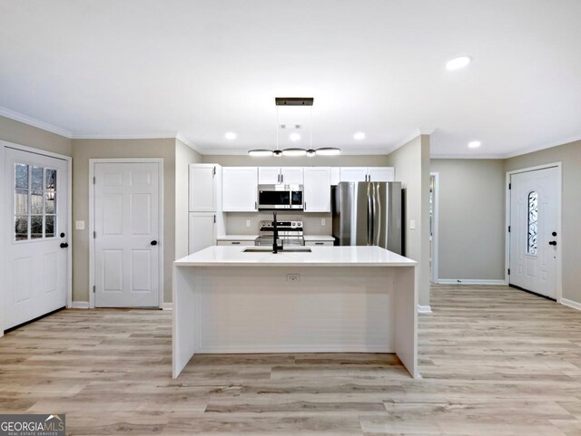 2308 Mark Trl, Decatur, GA 30032 - kitchen with appliances with stainless steel finishes, crown molding, white cabinetry, light wood finished floors, and light countertops