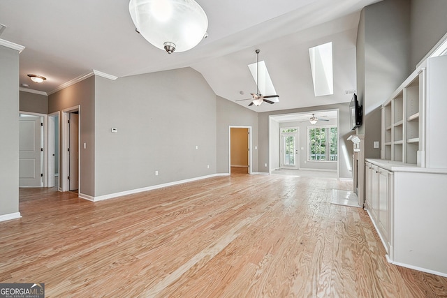 6722 Blue Heron Way, Flowery Branch, GA 30542 - unfurnished living room featuring ceiling fan, light wood-style floors, a skylight, vaulted ceiling, and crown molding