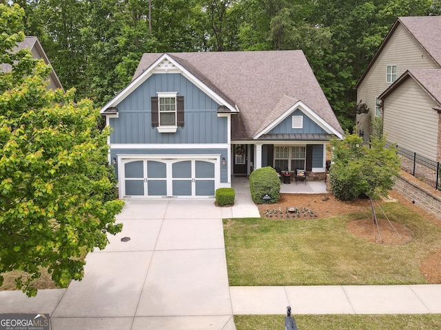 6722 Blue Heron Way, Flowery Branch, GA 30542 - view of front of house featuring board and batten siding, concrete driveway, a porch, a garage, and a shingled roof